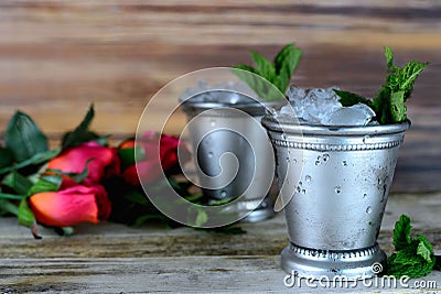 Image for Kentucky Derby in May showing two silver mint julep cups with crushed ice and fresh mint in a rustic setting Stock Photo