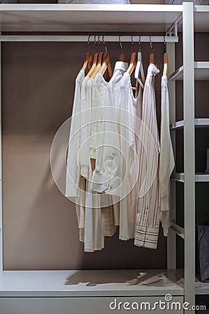 Light colored shirts hanging in the closet Stock Photo