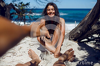 Image of a loved make touches his girlfriend`s, have funny times, on the beach of the Corsica. Stock Photo