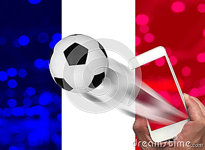 Male hand useing smartphone looking football world championship with bokeh and franch flag background Stock Photo