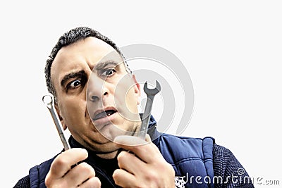 Image of a man wondering what the tool in his hand is for and how to use it. from the expression appears in disficulity Stock Photo