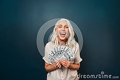 Mature happy old woman holding money. Stock Photo