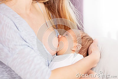 Image of the mother breastfeed little infant boy Stock Photo