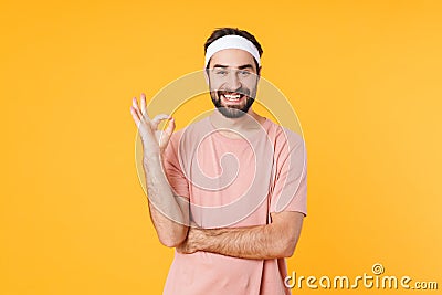 Image of muscular athletic young man smiling and gesturing ok fingers Stock Photo