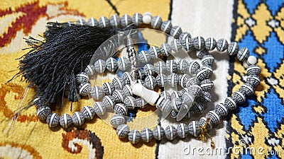 Image of Muslim prayer bead on prayer mat Stock Photo