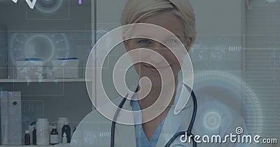 Image of numbers changing and scopes on screens over female doctor with stethoscope Stock Photo