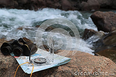 An image of old binoculars and a compass Stock Photo