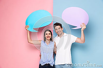 Image of optimistic couple holding copyspace commercial bubbles Stock Photo