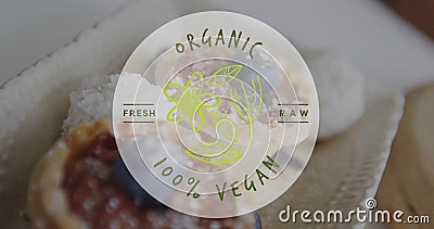 Image of organic 100 percent vegan text over cupcakes in background Stock Photo