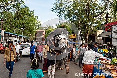 A majestic Tamil temple elephant walks down a busy street in India. Stock Photo Editorial Stock Photo