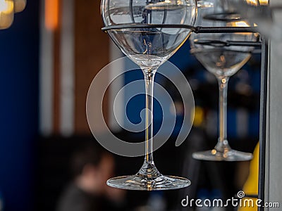 Image of a part of wine glasses hanging on a wall rack Stock Photo