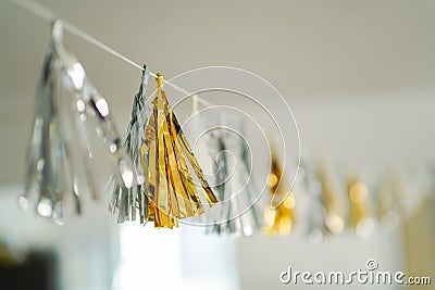 Image of Party tinsel garland draperi on the rope in silver and gold metallic colour Stock Photo