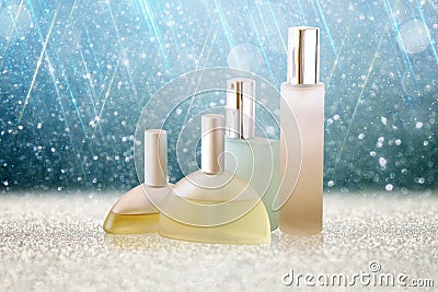 Image of perfume bottles isolated on glitter shiny background Stock Photo
