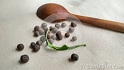 Pimento, allspice and wooden spoon Stock Photo