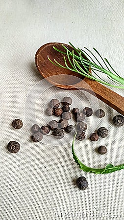 Pimento, allspice and wooden spoon, black pepper Stock Photo