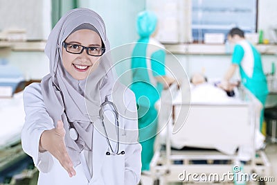 Muslim doctor offering handshake in the hospital Stock Photo