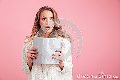 Pretty shocked lady reading book Stock Photo