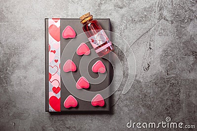 Red love potion with pink heart shaped sweets Stock Photo