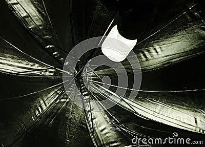 Image reflected in a dark shiny plate, a burner and an umbrella diffusing the light Stock Photo