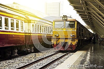 Train led by Old yellow Diesel Electric locomotives at Bangkok Railway Station Editorial Stock Photo