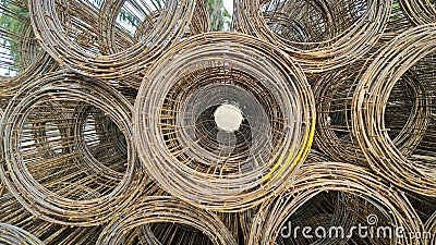 Roll up rusty steel rebar grid reinforcement frame lying on the ground for building construction usage. Stock Photo