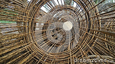 Roll up rusty steel rebar grid reinforcement frame lying on the ground for building construction usage. Stock Photo