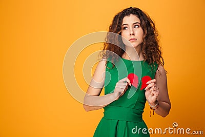 Sad young lady holding broken heart. Stock Photo