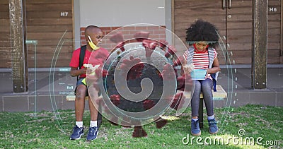 Image of scope over covid 19 cell with masked children social distancing eating at school Stock Photo