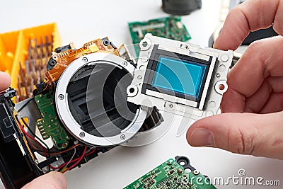 Image sensor digital SLR camera in hands of service engineer Stock Photo