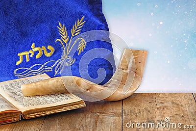 Image of shofar (horn) and prayer case with word talit (prayer) writen on it Stock Photo