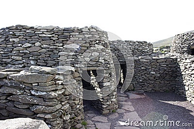 Colony of ancient stone beehive huts, or clochans, stone dry huts in Ireland Stock Photo