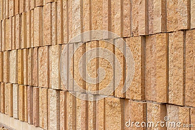 Modern rough textured limestone wall background with vertical aligned stone bricks Stock Photo
