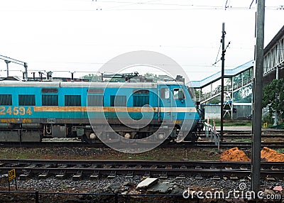 The image shows a train on railway tracks. Editorial Stock Photo