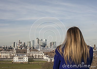 The Greenwich park, Canary Wharf and a tourist. Editorial Stock Photo