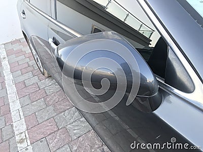 Image of an Side or rear mirror of an blue color four wheeler car with modern back light for better caution to view full size of Stock Photo