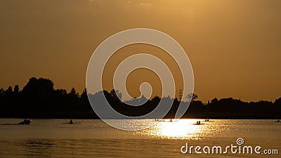 Image of silhouette of canoers on the Vistula river, Poland. Stock Photo