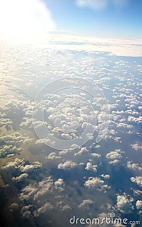 Little fluffy white clouds over a blue quiet sea Stock Photo