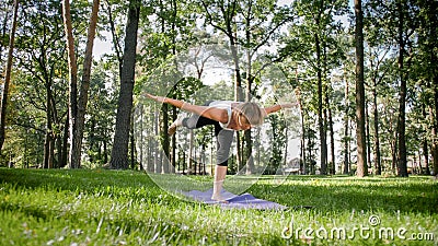 Photo of smiling woman doing yoga and fitness exercises. Middle aged people taking care of their health. Harmony of body Stock Photo