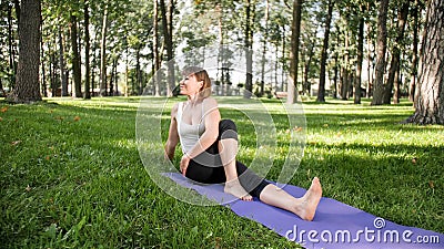 Photo of smiling woman doing yoga and fitness exercises. Middle aged people taking care of their health. Harmony of body Stock Photo