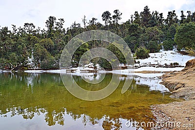 Deoria or Deoriya Tal Lake with Lush Green Trees and Snow - Winter Himalayan Landscape, Uttarakhand, India Stock Photo