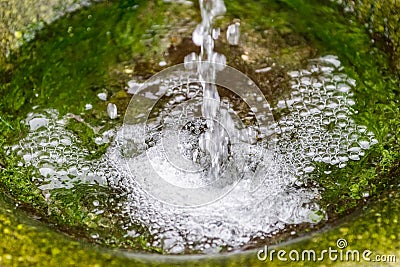 Source of drinking water in the stone close up Stock Photo