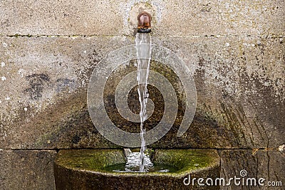 Source of drinking water in the stone close up Stock Photo