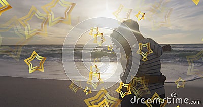Image of stars over biracial couple at beach Stock Photo