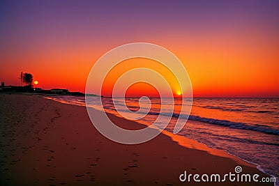 Stunning sunset on a sandy beach, Rimini, Italy, Adriatic sea, Europe. made with Generative AI Stock Photo