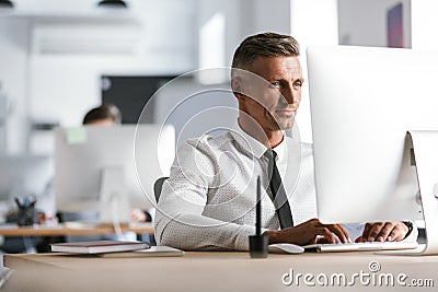 Image of successful employee man 30s wearing white shirt and tie Stock Photo