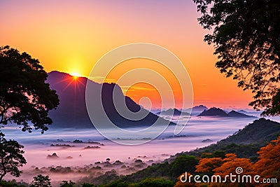 Sunrise over the moutain in Kanchanaburi, western provinve of Thailand, with silhouette trees in the Stock Photo