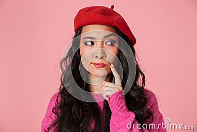 Image of thoughtful beautiful asian girl wearing beret thinking or hesitating Stock Photo