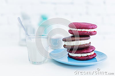 Image of three whoopie pies or moon pies with glass of milk and spoon. Stock Photo