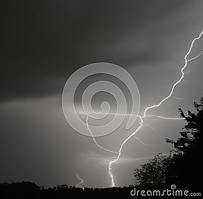 Image of thunder lightning against grey stormy sky with copy space Stock Photo