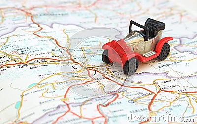 Image travel concept, small red, black car on map Stock Photo